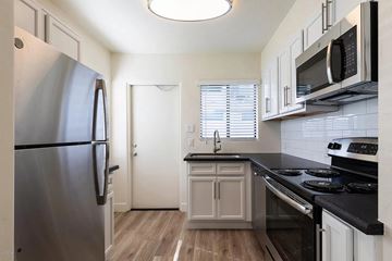 Phoenix apartment for rent - a kitchen with stainless steel appliances and white cabinets