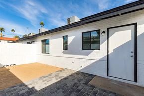 Phoenix apartment for rent - a white brick house with a white garage door