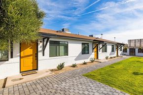 Phoenix apartment for rent - the front of a white house with yellow doors