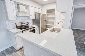 Mesa apartment for rent - a kitchen with white cabinets and stainless steel appliances