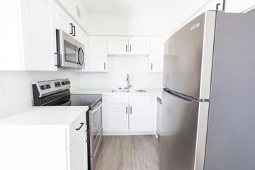 Phoenix apartment for rent - a white kitchen with stainless steel appliances and white cabinets