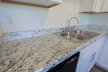 Phoenix apartment for rent - A kitchen counter with a sink and a dishwasher.