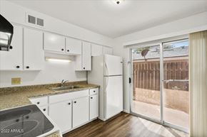 Phoenix apartment for rent - a kitchen with white cabinets and a sliding glass door