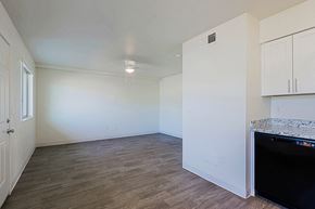 Phoenix apartment for rent - A kitchen area with a black fridge and wooden flooring.