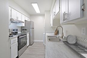 Phoenix apartment for rent - a spacious kitchen with stainless steel appliances and white cabinets