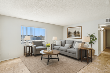 Glendale apartment for rent - A living room with a grey couch, a coffee table, and a painting on the wall.