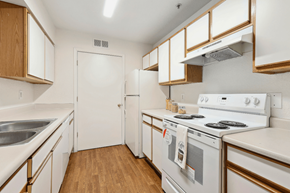Yuma apartment for rent - a kitchen with white appliances and wooden cabinets