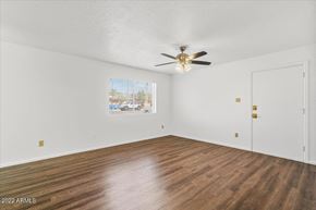 Phoenix apartment for rent - an empty living room with white walls and a ceiling fan