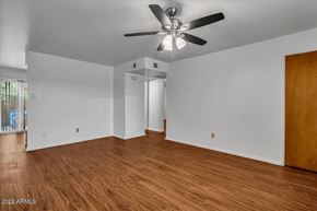 Phoenix apartment for rent - an empty living room with wood floors and a ceiling fan