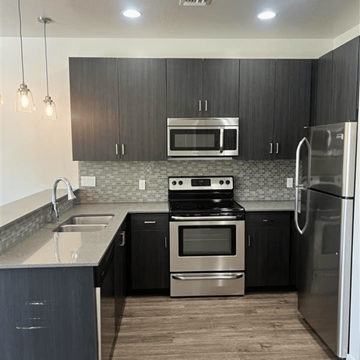 Scottsdale apartment for rent - a kitchen with black cabinets and stainless steel appliances