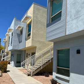 Scottsdale apartment for rent - a row of apartments with stairs and balconies on a sunny day
