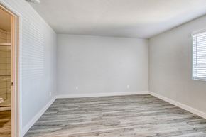 Mesa apartment for rent - an empty bedroom with wood flooring and white walls