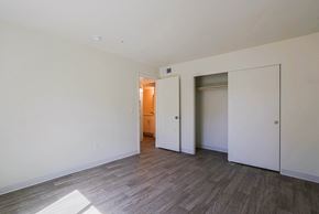 Phoenix apartment for rent - A room with a wooden floor and white walls.