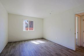 Phoenix apartment for rent - A room with a window and wooden floors.