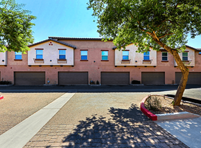 Glendale townhouse for rent - A tree is in front of a building with a red planter.