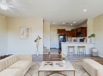 Glendale townhouse for rent - A living room with a white couch, a coffee table, and a kitchen area in the background.