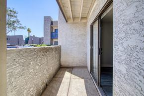 Mesa apartment for rent - a patio with a door and a wall and a pool