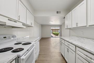 Glendale apartment for rent - A white kitchen with a stove top oven and cabinets.