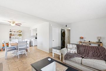 Glendale apartment for rent - A living room with a grey couch and a dining table.