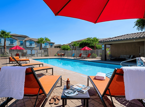 Glendale townhouse for rent - A poolside area with chairs and umbrellas.