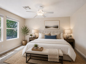 Glendale townhouse for rent - A bedroom with a large bed and a ceiling fan.