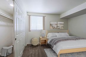 Phoenix apartment for rent - A bedroom with a bed, nightstand, and window.