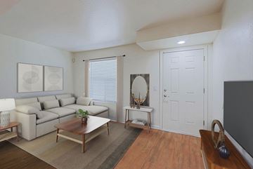 Phoenix apartment for rent - A living room with a white couch and a wooden coffee table.