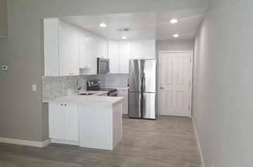 Phoenix apartment for rent - a kitchen with white cabinets and a stainless steel refrigerator
