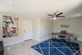 Tempe townhouse for rent - a home office with a desk and a ceiling fan