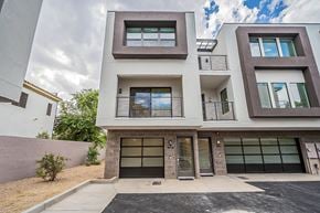 Tempe townhouse for rent - the front facade of a condo building with glass doors and windows