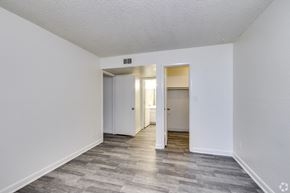 Glendale apartment for rent - the living room of an apartment with white walls and wood flooring