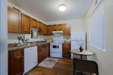 Phoenix apartment for rent - A kitchen with wooden cabinets and white appliances.