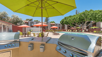 Poolside bbq and picninc area with lime green umbrella