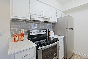 View of kitchen with white cabintery