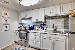 Glendale apartment for rent - a kitchen with white cabinets and stainless steel appliances and a sink at Summers Point Apartments, Glendale, 85301