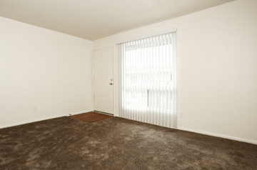 Phoenix apartment for rent - a living room with carpet and a sliding glass door