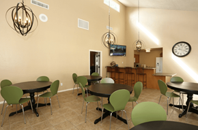 Phoenix apartment for rent - a dining room with tables and chairs and a clock on the wall