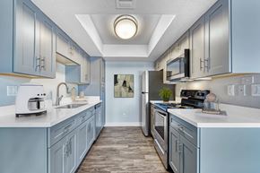 Glendale apartment for rent - A kitchen with a white counter top and a sink at Tela Verde Apartment Homes, Glendale, 85306