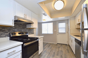 Phoenix apartment for rent - a kitchen with white cabinets and a black stove top oven