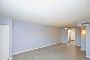 Phoenix apartment for rent - an empty living room with a ceiling fan