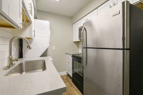 Tempe apartment for rent - a kitchen with a stainless steel refrigerator and sink