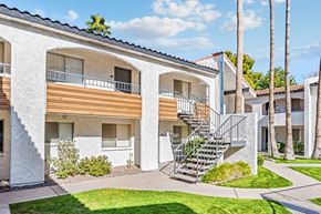 Phoenix apartment for rent - A white building with a balcony and a staircase at Tides on East Cactus Apartments, Arizona