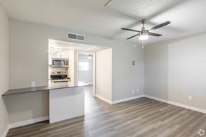 Phoenix apartment for rent - A room with a ceiling fan and a kitchenette in the background at Tides on East Cactus Apartments, Phoenix, AZ