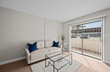 Phoenix apartment for rent - A living room with a white couch and a glass coffee table.