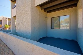 Phoenix triplex for rent - a porch of a building with a door and a window