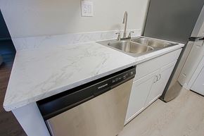 Phoenix triplex for rent - a kitchen with white marble counter top and a dishwasher