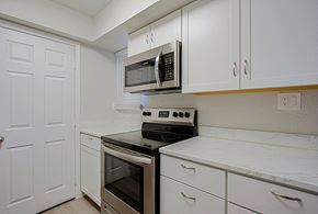 Phoenix triplex for rent - a kitchen with stainless steel appliances and white cabinets