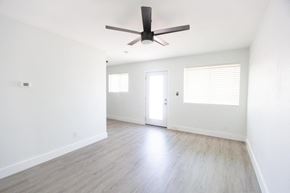 Phoenix apartment for rent - an empty living room with white walls and a ceiling fan
