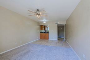 Scottsdale townhouse for rent - A spacious room with a ceiling fan and a carpeted floor.