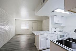 Phoenix apartment for rent - A kitchen with white cabinets and a stove top oven.
